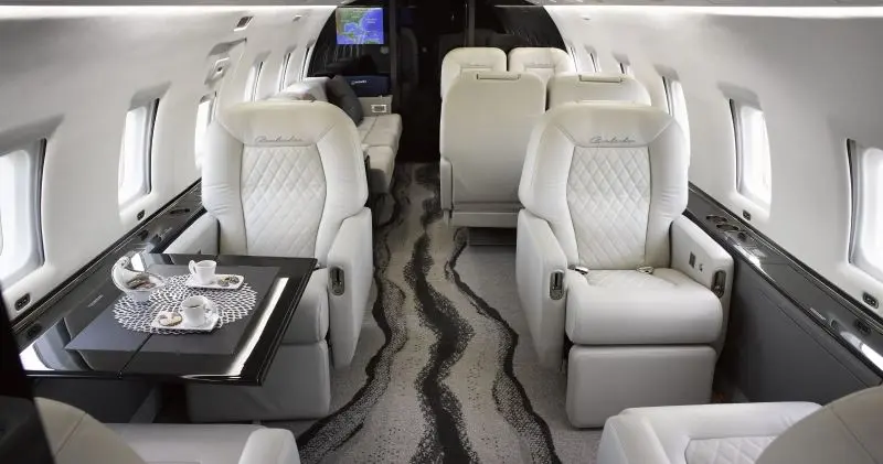 Challenger 604 forward galley and enclosed lavatory on private charter flight