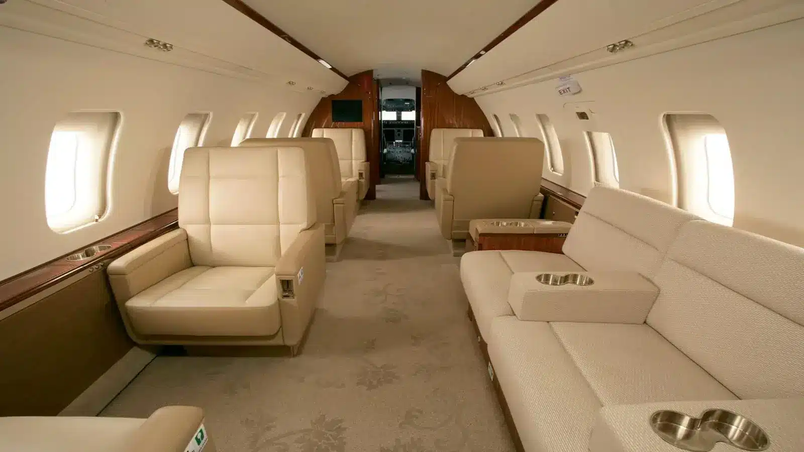 Challenger 605 private jet interior — refined cabin and full galley for intercontinental charter