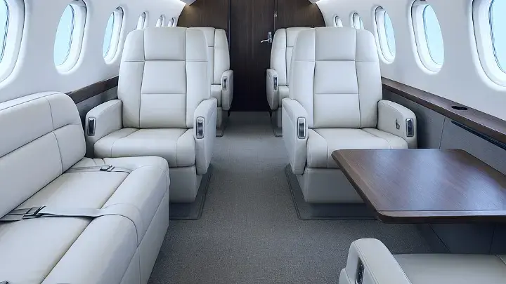 Dassault Falcon 2000 heavy private jet — wide cabin interior with stand-up headroom and flat floor for 8 to 10 passengers