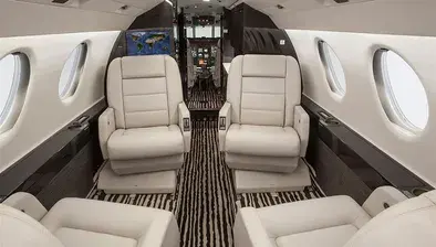 Dassault Falcon 50 private jet — trijet super-midsize cabin with stand-up headroom and strong runway performance for challenging airport access